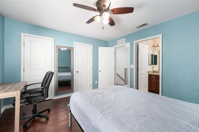 a bedroom with a bed a desk and chair