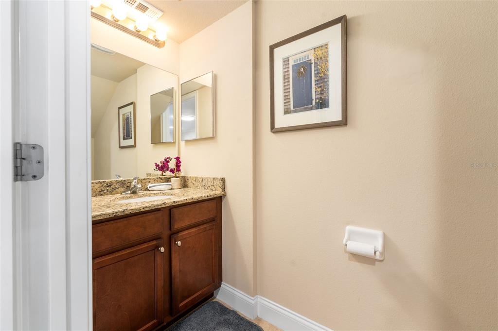 4639 Southwest 48th Drive, Unit 151 Gainesville, FL 32608 - Photo 7 of 26 a bathroom with a granite countertop sink mirror and vanity