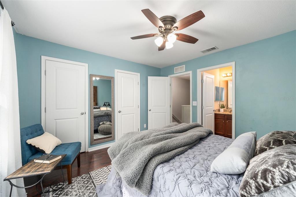 4639 Southwest 48th Drive, Unit 151 Gainesville, FL 32608 - Photo 9 of 26 a bedroom with a large bed and a chandelier