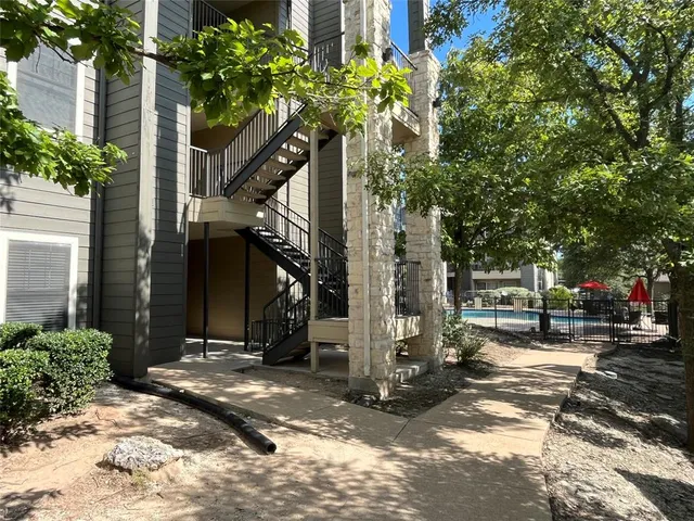 a view of a house with a tree in front