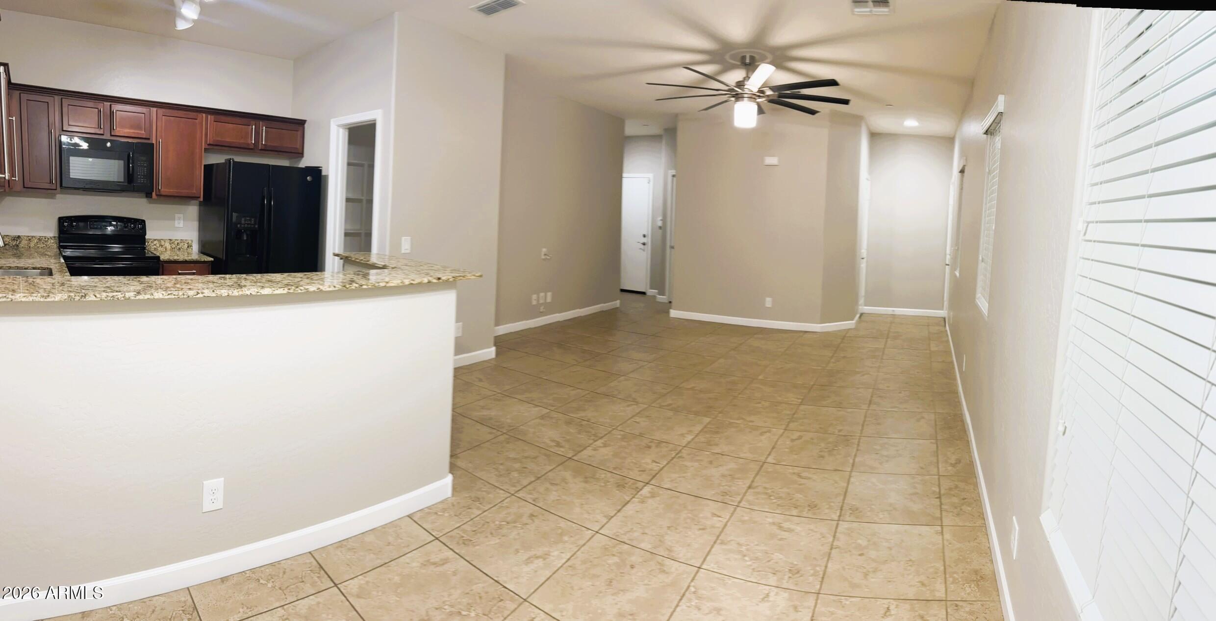 2150 West Alameda Road, Unit 1265 Phoenix, AZ 85085 - Photo 5 of 25 a view of a kitchen with furniture and a ceiling fan