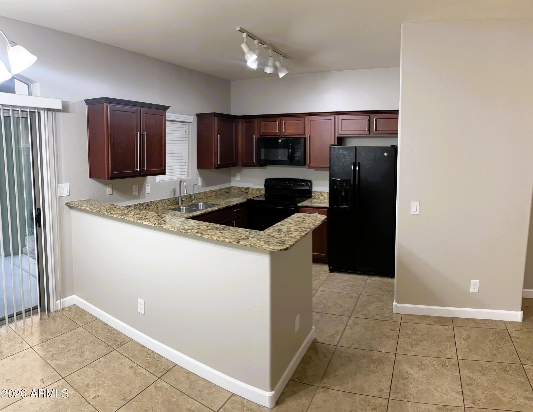 2150 West Alameda Road, Unit 1265 Phoenix, AZ 85085 - Photo 6 of 25 a kitchen with stainless steel appliances granite countertop a refrigerator and a sink