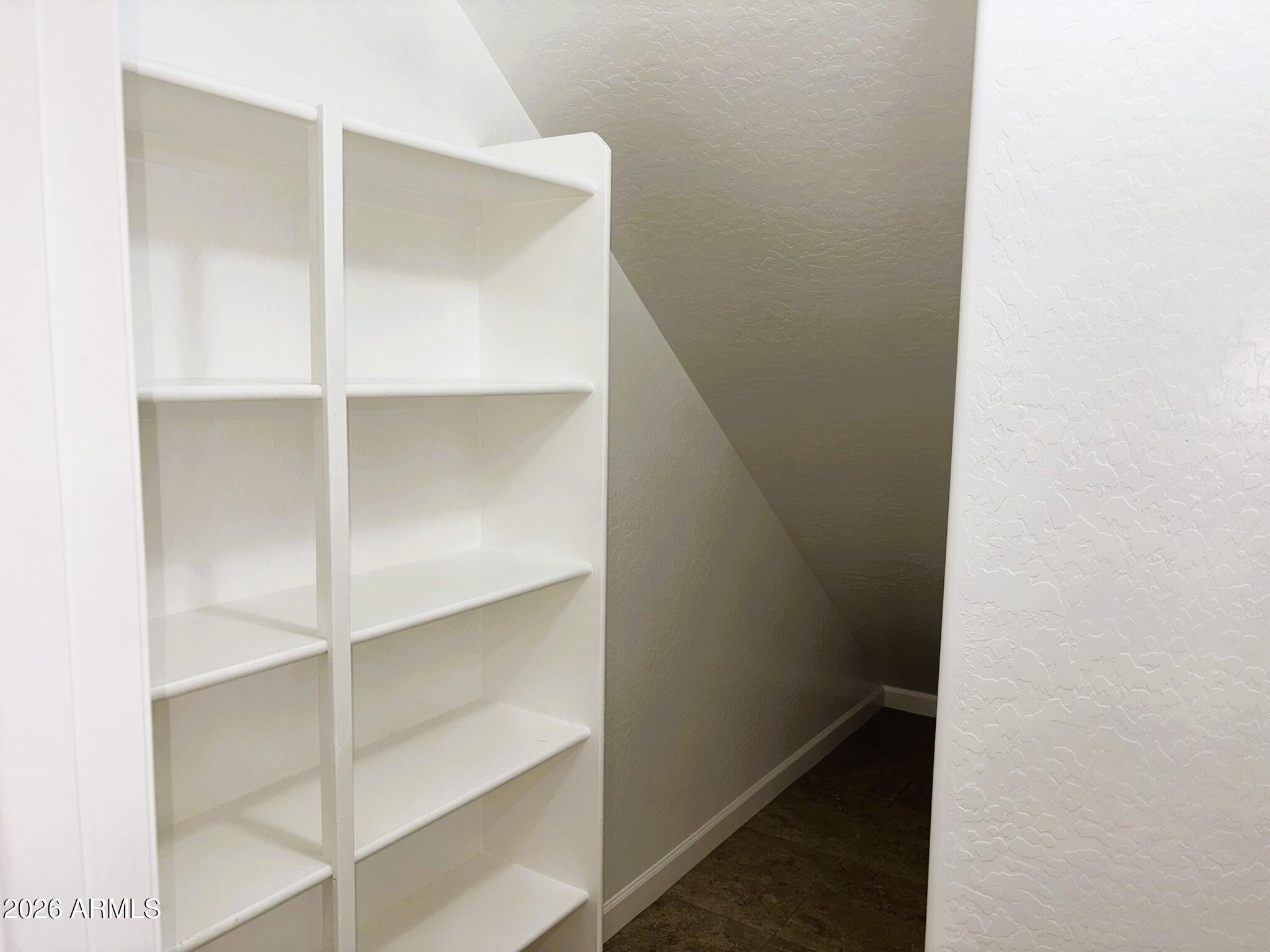 2150 West Alameda Road, Unit 1265 Phoenix, AZ 85085 - Photo 7 of 25 a view of walk in closet with empty racks