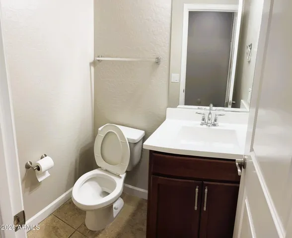 a bathroom with a sink toilet and a mirror