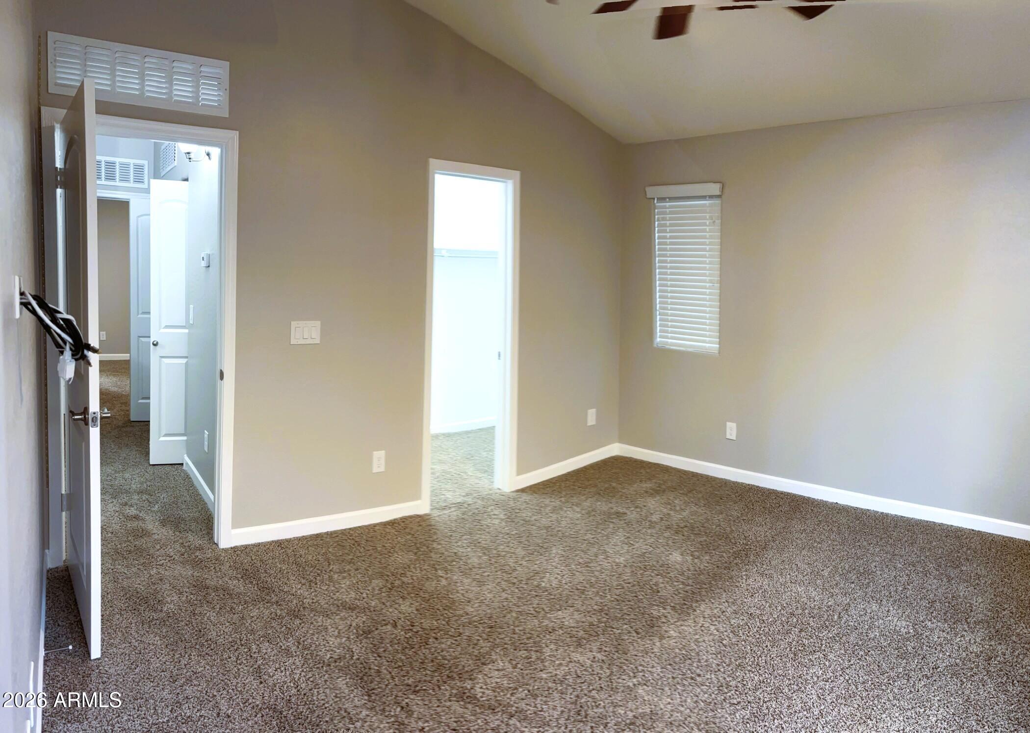 2150 West Alameda Road, Unit 1265 Phoenix, AZ 85085 - Photo 10 of 25 an empty room that has a glass door