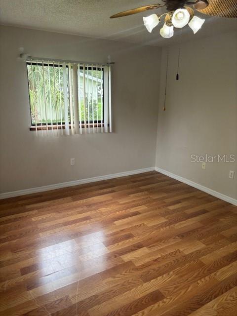 10405 Southwest 98th Terrace Ocala, FL 34481 - Photo 13 of 18 a view of an empty room with wooden floor and a window