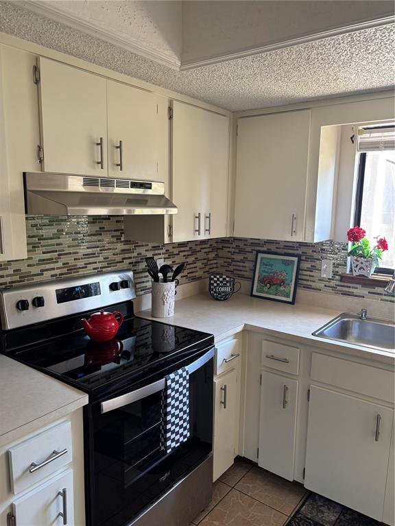 10405 Southwest 98th Terrace Ocala, FL 34481 - Photo 5 of 18 a kitchen with stainless steel appliances granite countertop a stove and a sink