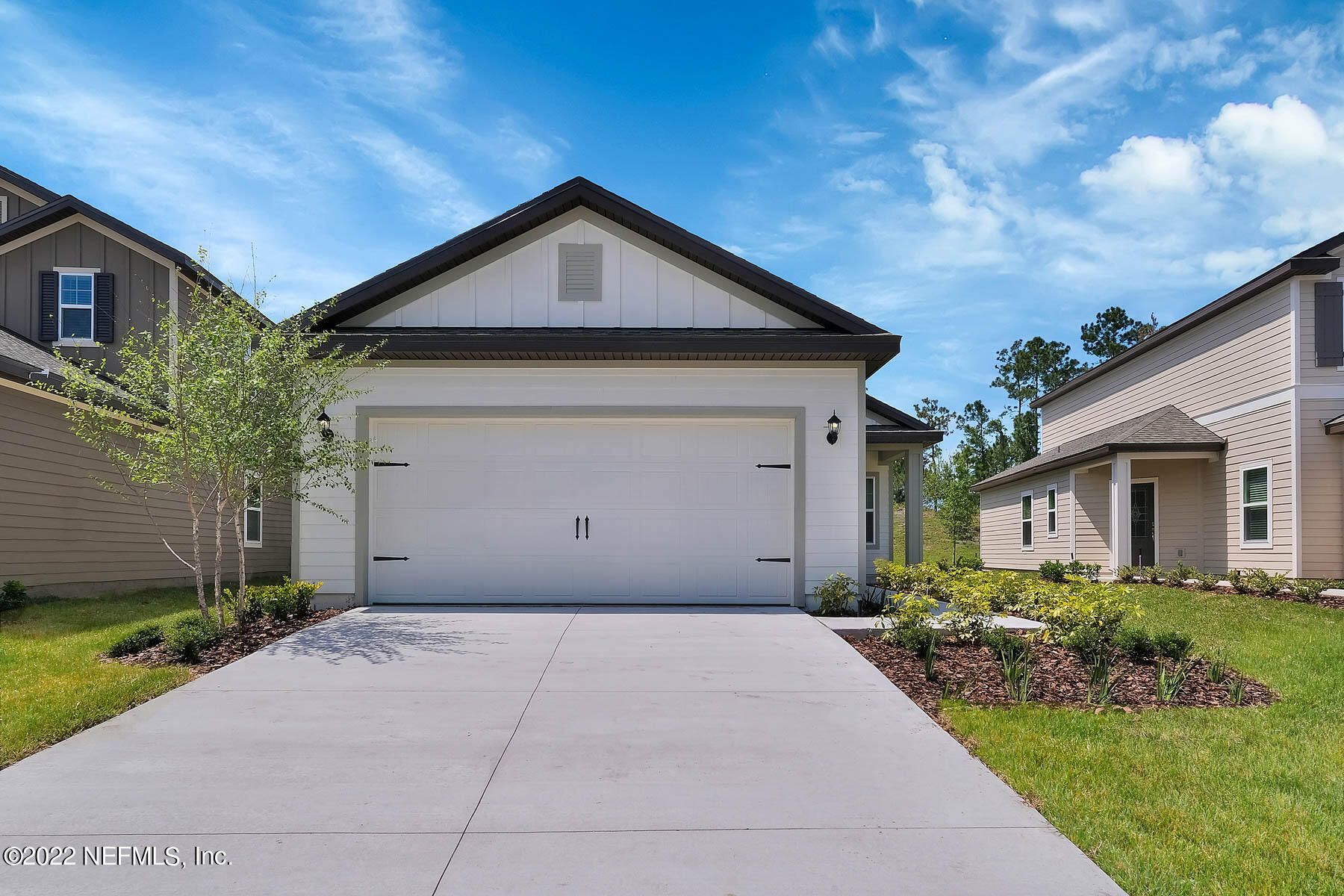 80 Falcon Ridge Road St. Augustine, FL 32084 - Photo 1 of 11 a front view of a house with a yard and garage