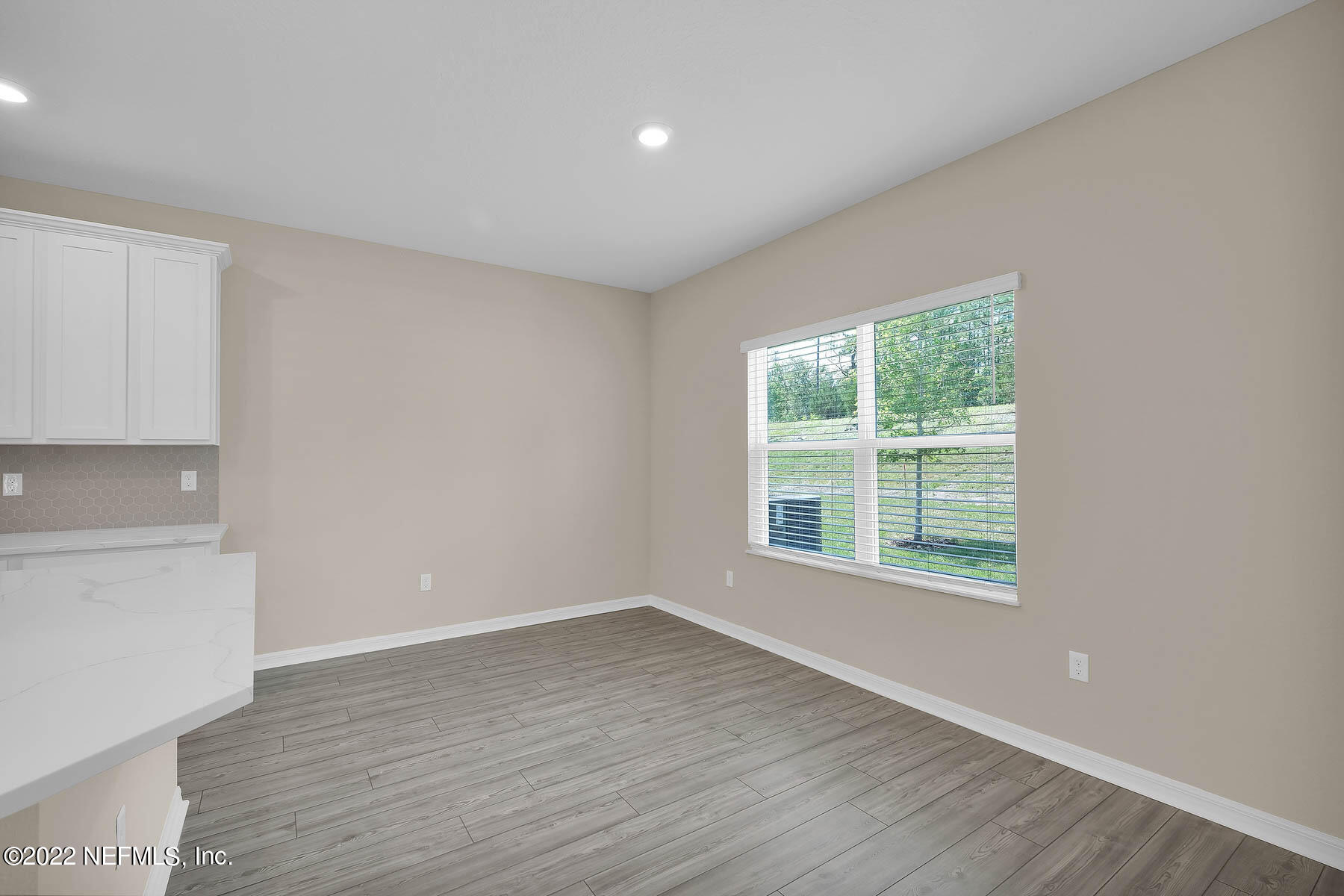80 Falcon Ridge Road St. Augustine, FL 32084 - Photo 4 of 11 an empty room with wooden floor and windows