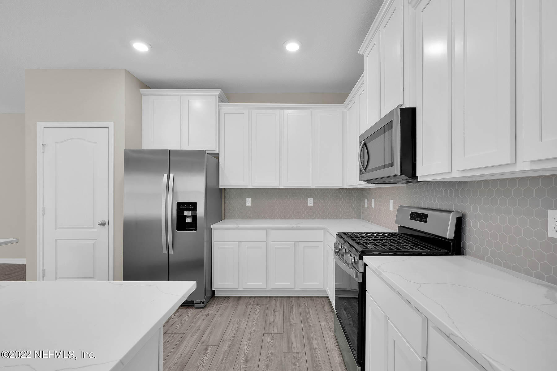 80 Falcon Ridge Road St. Augustine, FL 32084 - Photo 6 of 11 a kitchen with stainless steel appliances a refrigerator sink microwave and cabinets