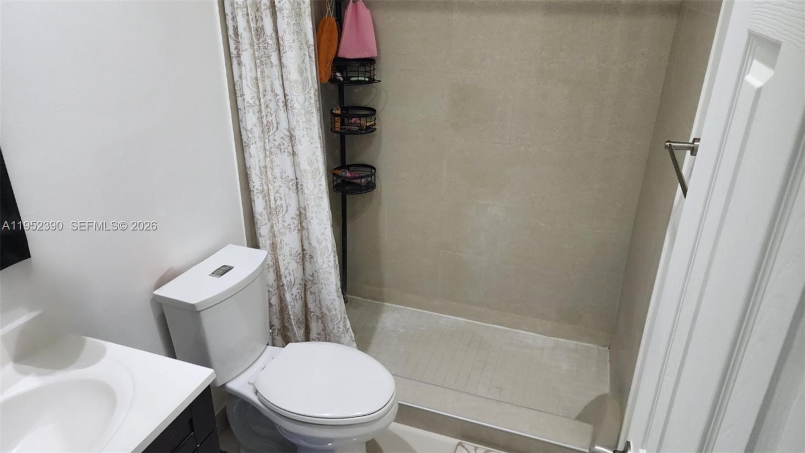 13337 Southwest 112th Place Miami, FL 33176 - Photo 3 of 14 a white toilet sitting next to a bath tub