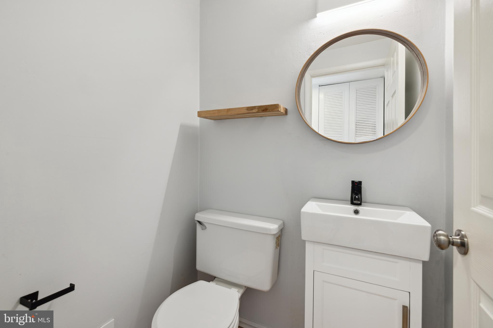 17680 Kohlhoss Road Poolesville, MD 20837 - Photo 9 of 30 a bathroom with a toilet a sink and a mirror