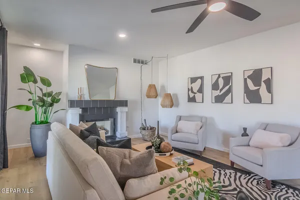 a kitchen with center island white cabinets and couches