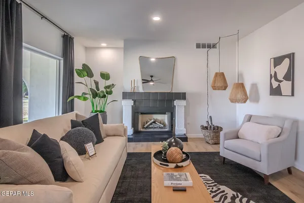 a kitchen with stainless steel appliances kitchen island granite countertop a refrigerator a stove a sink dishwasher a dining table and chairs with wooden floor