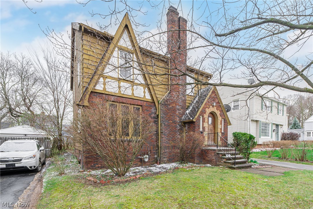 1211 Yellowstone Road Cleveland, OH 44121 - Photo 2 of 8 Tudor-style house with a front lawn