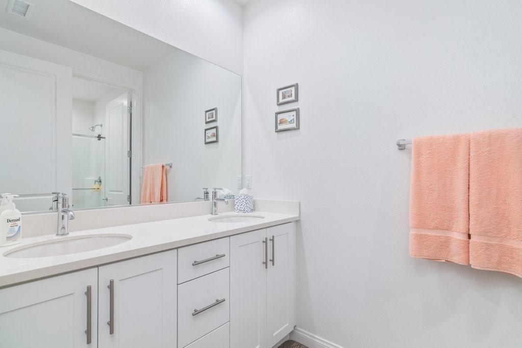 32250 Olea Way Temecula, CA 92591 - Photo 14 of 39 a bathroom with a double vanity sink and a mirror