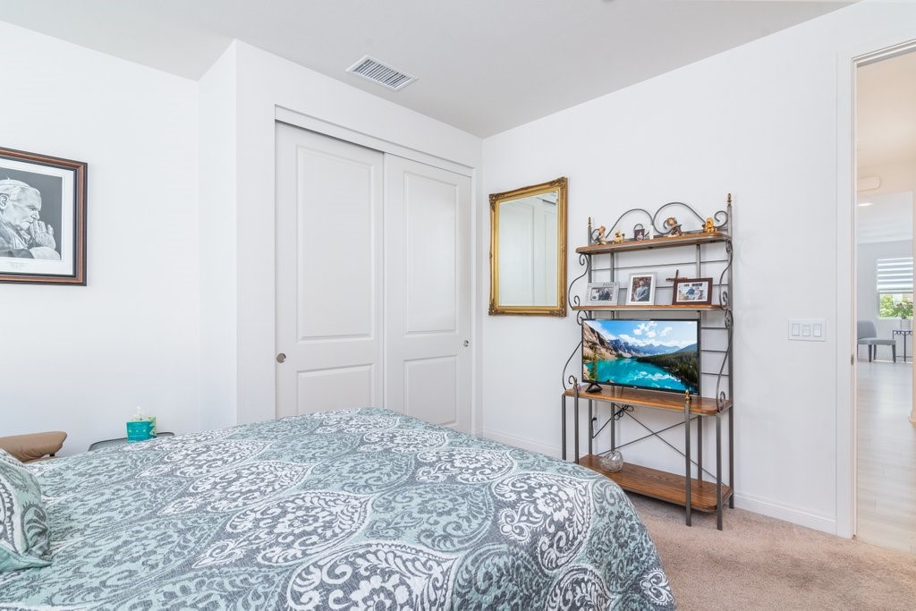 32250 Olea Way Temecula, CA 92591 - Photo 18 of 39 a bedroom with a bed table and chair