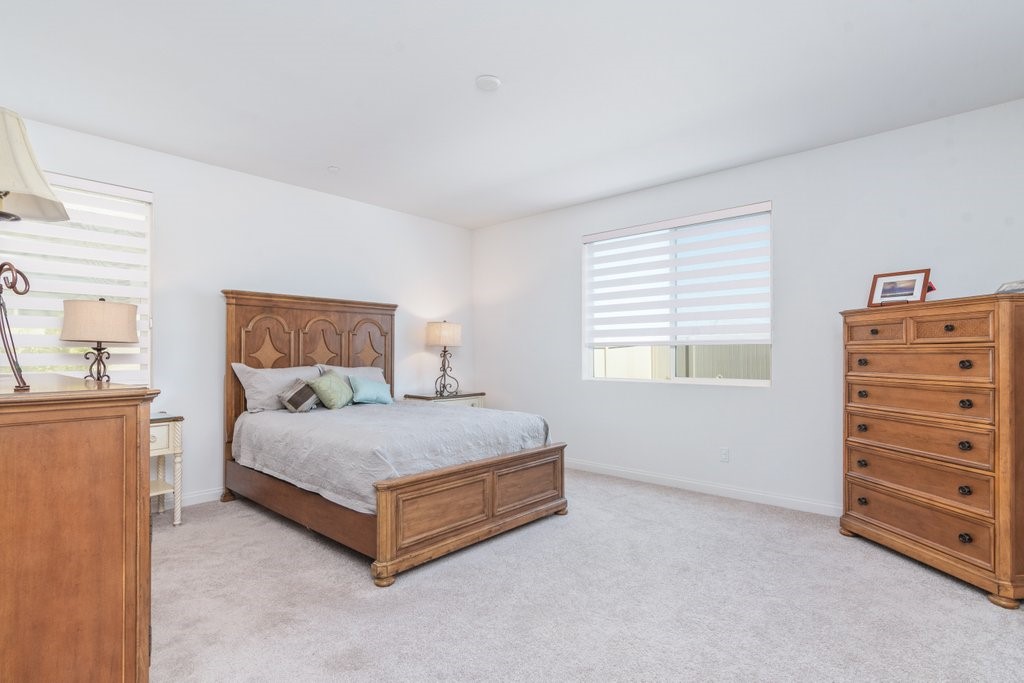 32250 Olea Way Temecula, CA 92591 - Photo 19 of 39 a spacious bedroom with a bed and a window