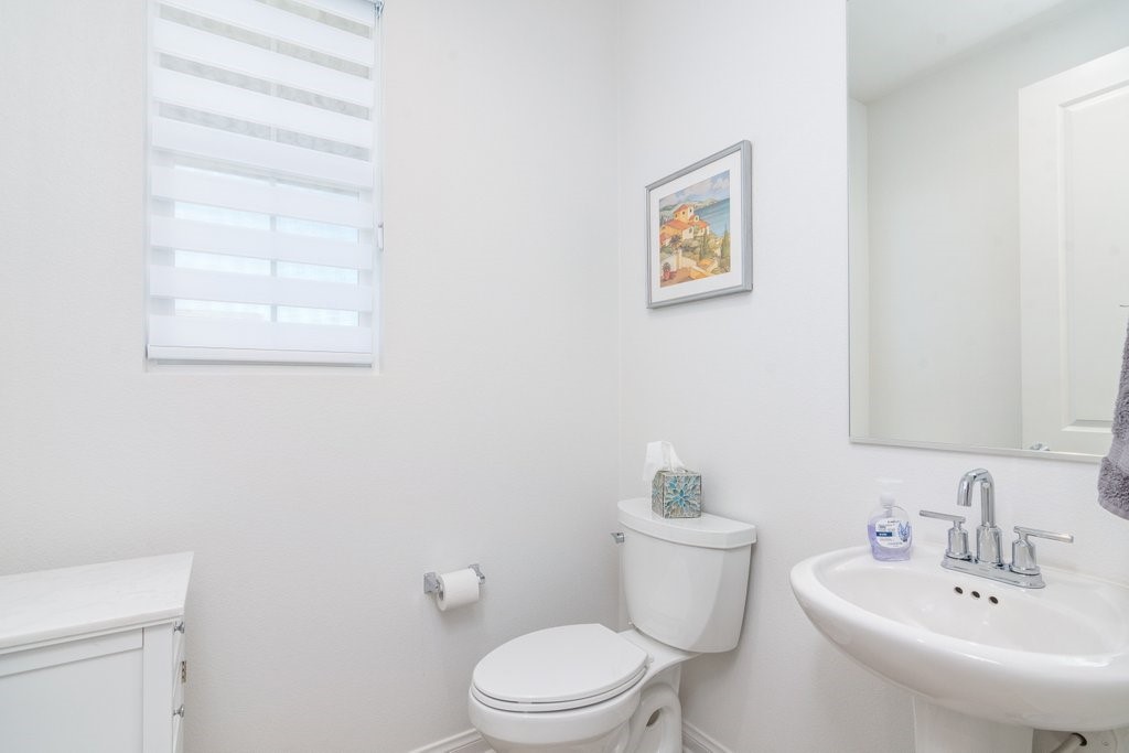 32250 Olea Way Temecula, CA 92591 - Photo 24 of 39 a bathroom with a toilet a sink and mirror
