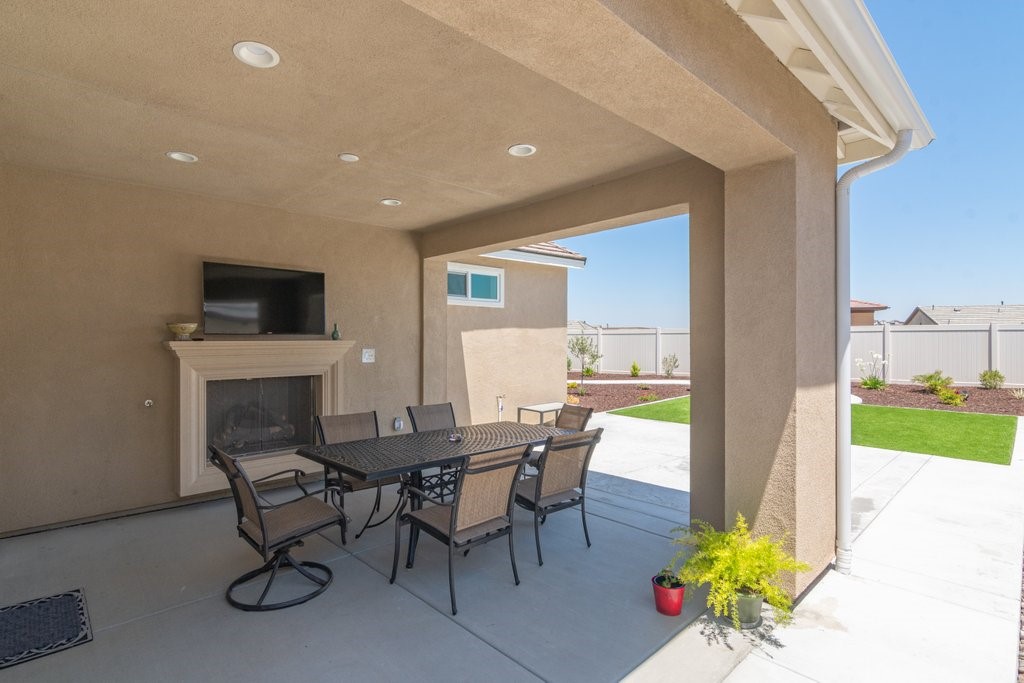 32250 Olea Way Temecula, CA 92591 - Photo 25 of 39 a view of a dining room with furniture and a fire place