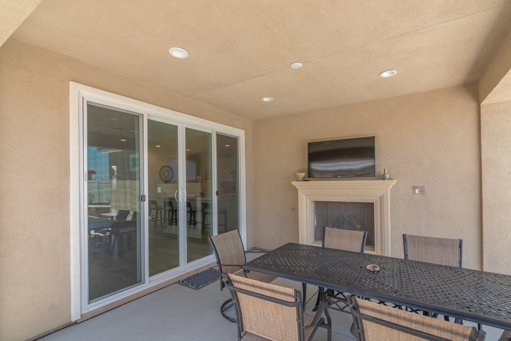32250 Olea Way Temecula, CA 92591 - Photo 27 of 39 a living room with furniture a fireplace and a flat screen tv