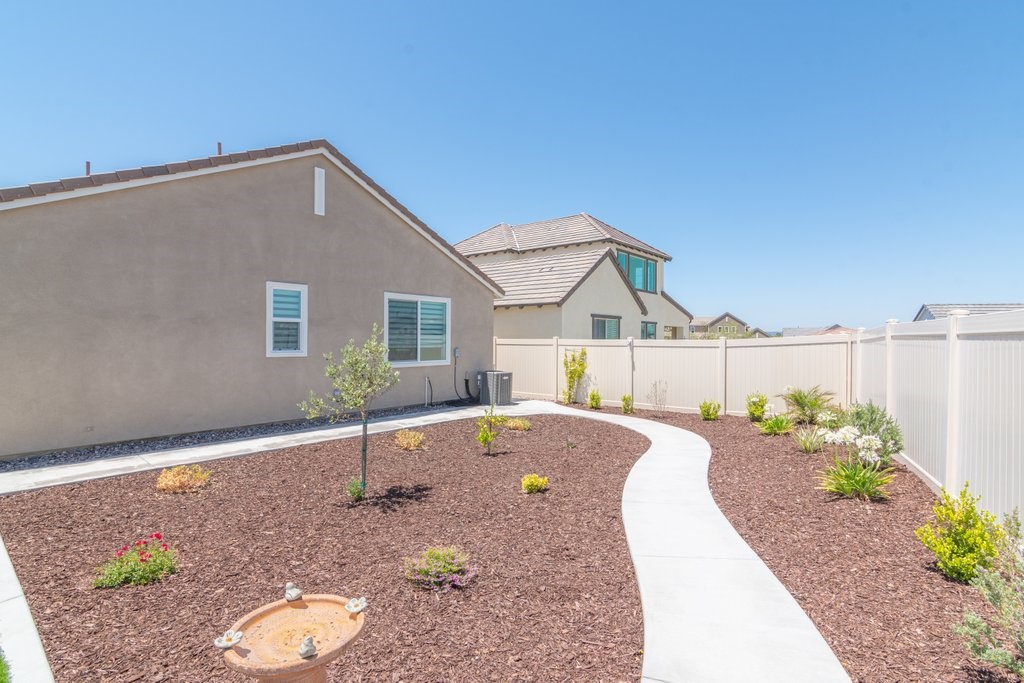 32250 Olea Way Temecula, CA 92591 - Photo 29 of 39 a view of a house with a yard and potted plants