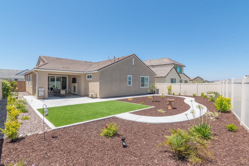 32250 Olea Way Temecula, CA 92591 - Photo 3 of 39 a front view of a house with a yard and garage