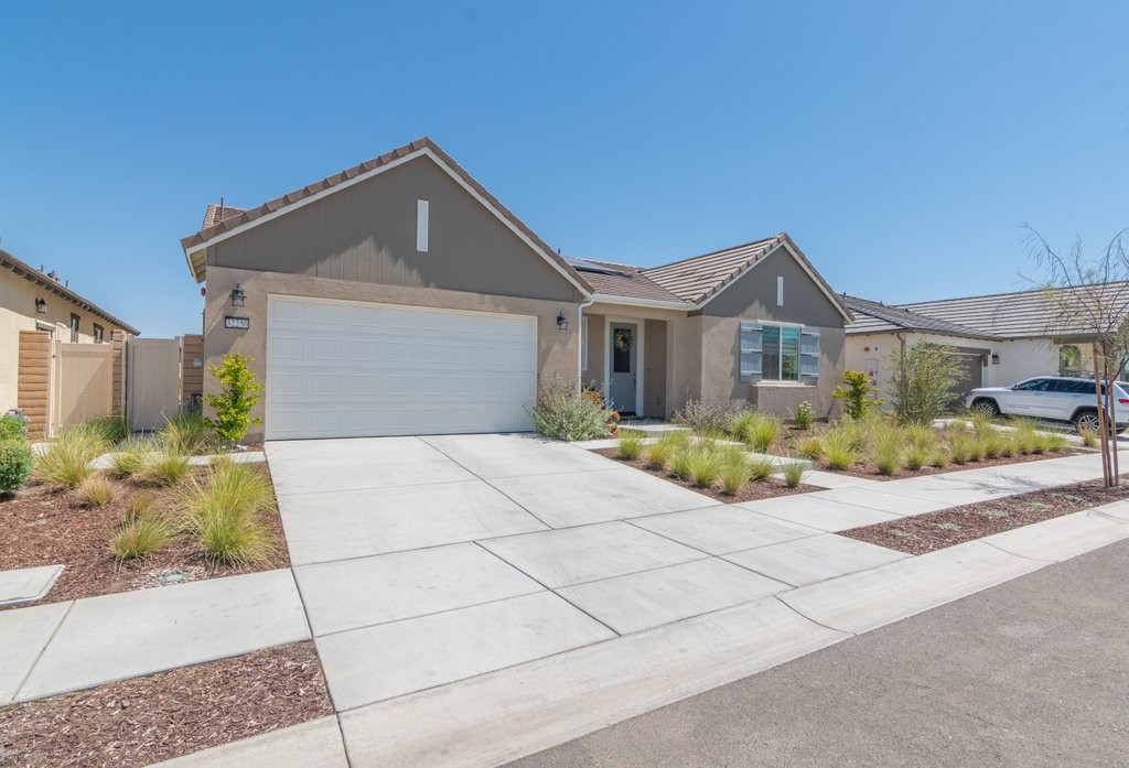 32250 Olea Way Temecula, CA 92591 - Photo 4 of 39 a front view of a house with a yard and potted plants