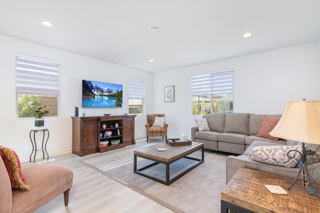 32250 Olea Way Temecula, CA 92591 - Photo 6 of 39 a living room with furniture a fireplace and a flat screen tv