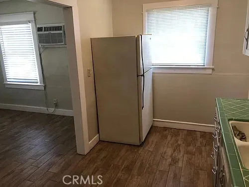 an empty room with wooden floor and a window