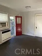 a view of an empty room with a kitchen