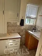 a kitchen with a sink stove and cabinets