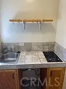 an oven with granite countertop a sink and a stove