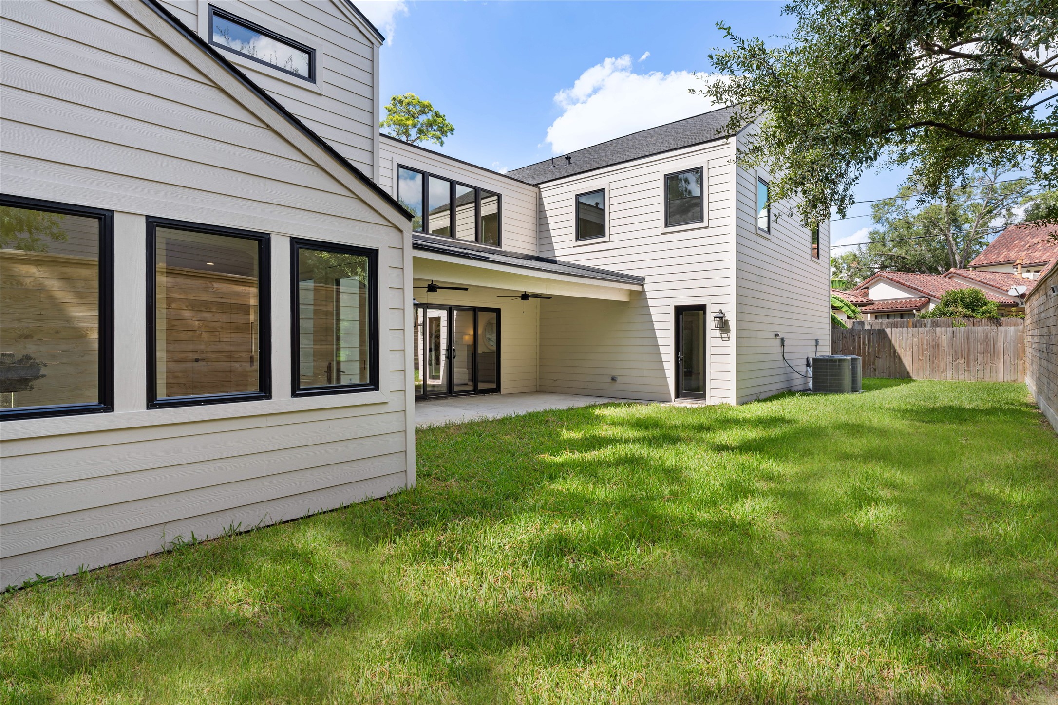 814 Azalea Street Houston, TX 77018 - Photo 27 of 31 Enjoy seamless indoor-outdoor living with this covered patio overlooking a private backyard—ideal for gatherings or quiet evenings at home