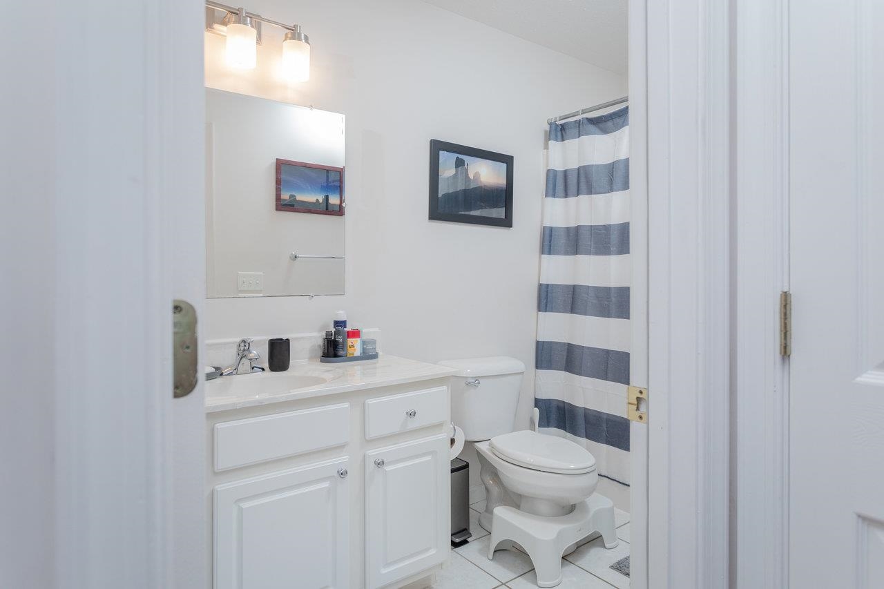 3750 Davis Road Penn Laird, VA 22846 - Photo 42 of 73 a bathroom with a granite countertop toilet a sink and a mirror