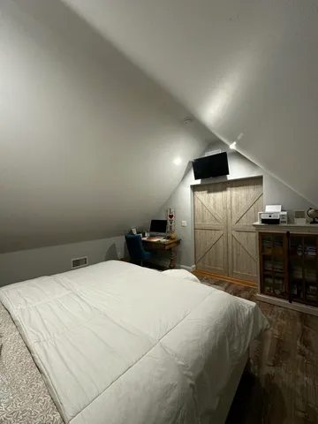 a bedroom with a bed and a walk in closet