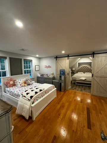 a living room with couches and kitchen view