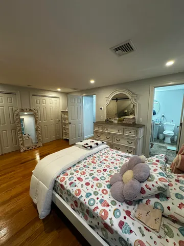 a bedroom with a bed and a dresser in it