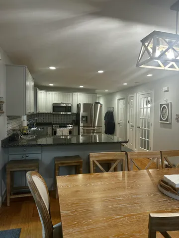 a kitchen with stainless steel appliances granite countertop a sink counter space and cabinets