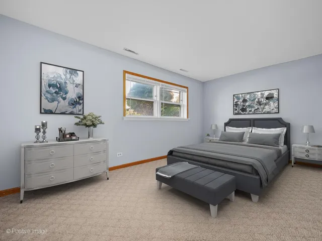 a spacious bedroom with a bed and a window