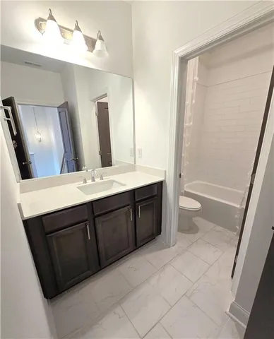 a bathroom with a toilet and a bathtub