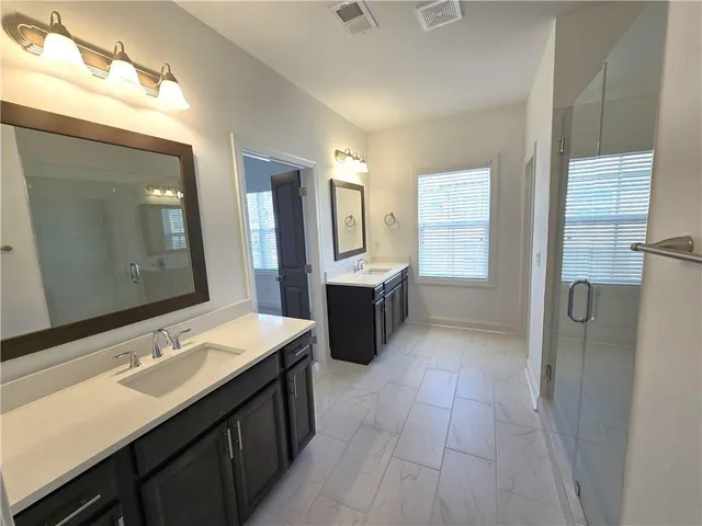 a bathroom with a glass door shower