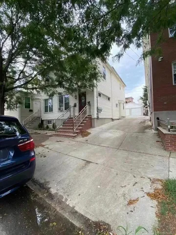 a car parked in front of white house