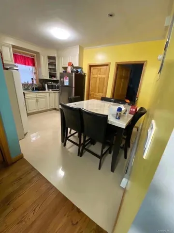a view of a dining room with furniture and a chandelier