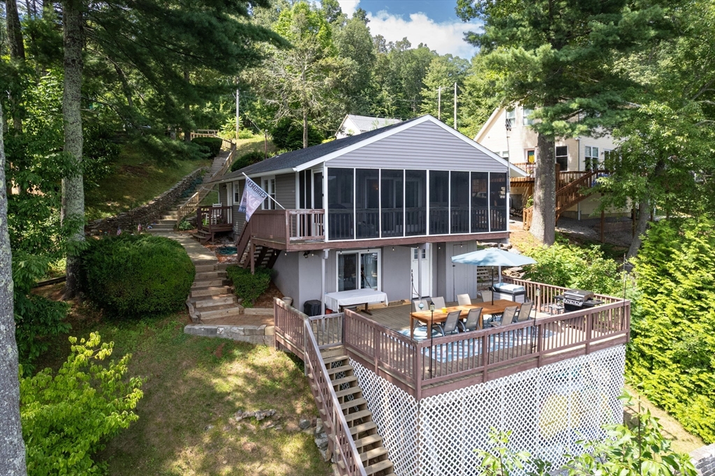 53 Sandy Beach Road Holland, MA 01521 - Photo 1 of 40 a front view of a house with garden