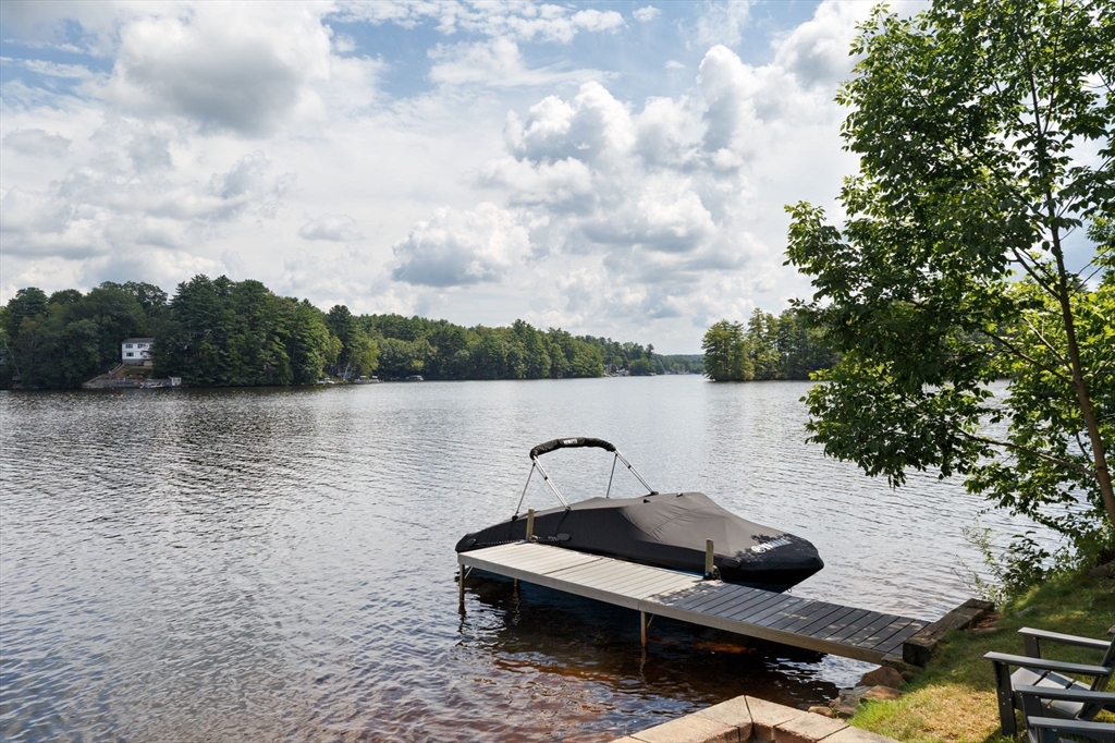 53 Sandy Beach Road Holland, MA 01521 - Photo 12 of 40 a front view of a lake with houses in the back