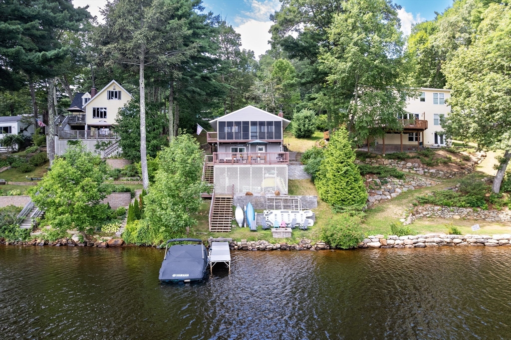 53 Sandy Beach Road Holland, MA 01521 - Photo 2 of 40 an aerial view of a house with pool lake view and trees all around