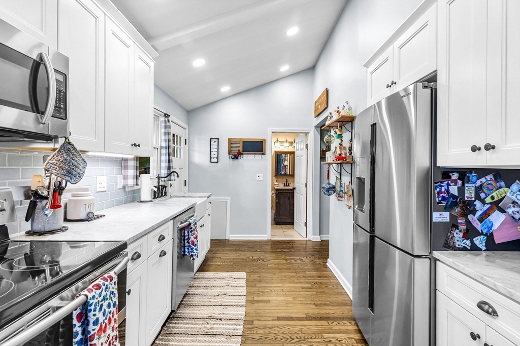 53 Sandy Beach Road Holland, MA 01521 - Photo 22 of 40 a kitchen with stainless steel appliances granite countertop a refrigerator and a stove