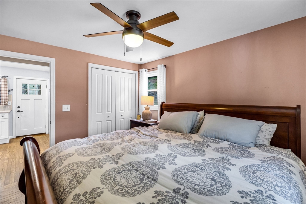 53 Sandy Beach Road Holland, MA 01521 - Photo 27 of 40 a bedroom with a large bed and a chandelier