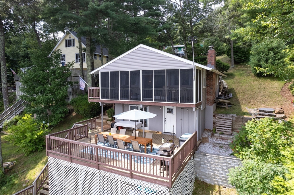 53 Sandy Beach Road Holland, MA 01521 - Photo 3 of 40 a balcony with table and chairs